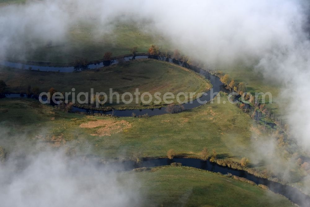 Spreenhagen from above - Curved loop of the riparian zones on the course of the river Nebel- und wolkenverhangenen in Spreenhagen in the state Brandenburg