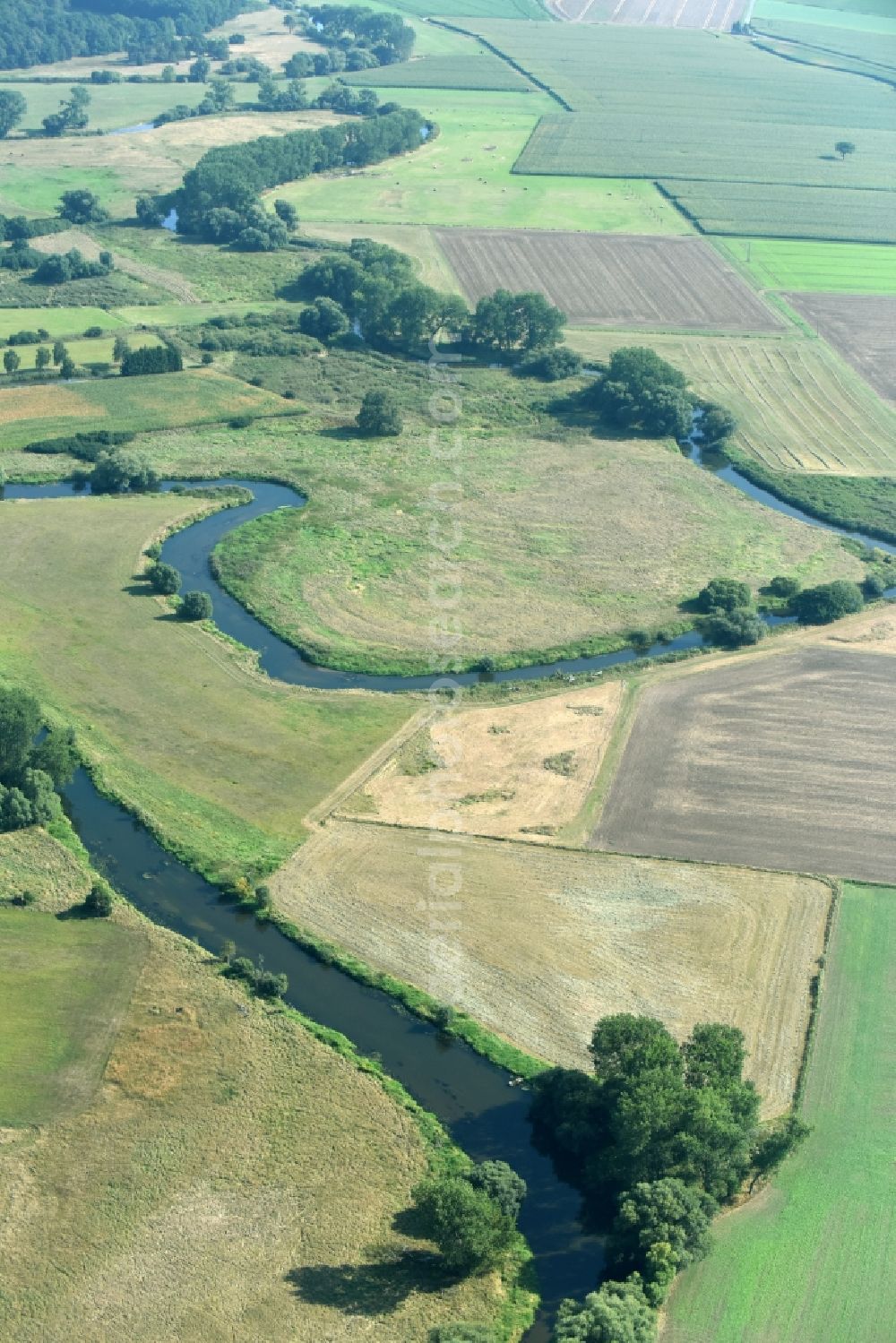 Meinersen from the bird's eye view: Curved loop of the riparian zones on the course of the river Oker in Meinersen in the state Lower Saxony