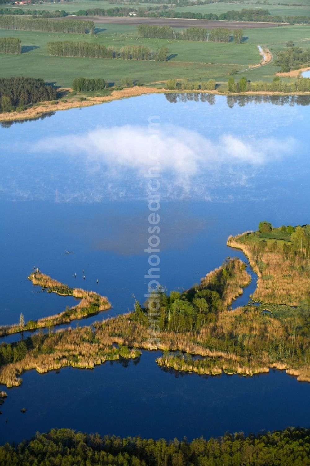 Dreetz from above - Shore areas at the lake area of Lake Dreetz and clouds above the water surface in Dreetz in the federal state Brandenburg, Germany