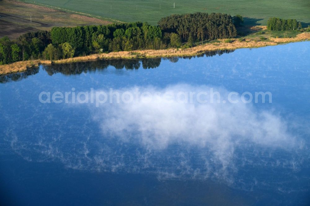 Dreetz from the bird's eye view: Shore areas at the lake area of Lake Dreetz and clouds above the water surface in Dreetz in the federal state Brandenburg, Germany