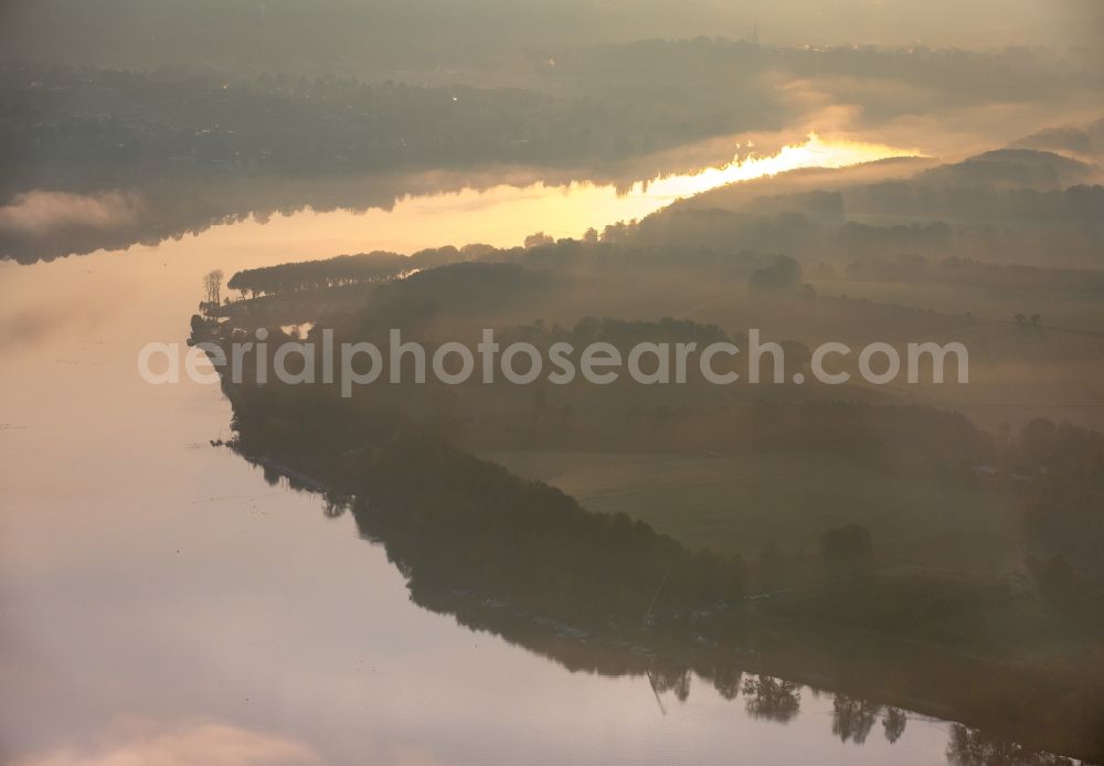 Aerial image Essen - Autumn weather with fog and mist in the sunset at the shore areas in the sea area of the Baldeneysee in Essen in North Rhine-Westphalia