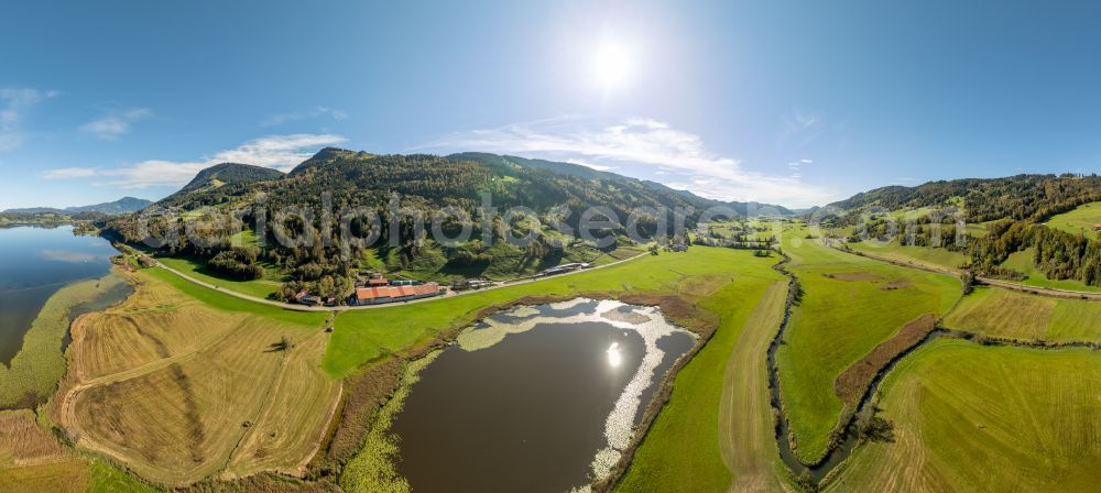 Immenstadt im Allgäu from the bird's eye view: Shore areas at the lake area of Grosser Alpsee in the valley of the mountain landscape in Immenstadt im Allgaeu in the state Bavaria, Germany