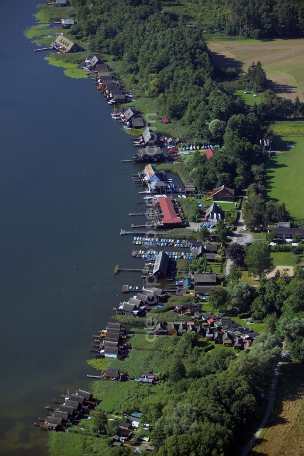 Aerial image Güstrow - Riparian areas on the lake area of the Inselsee with piers in Guestrow in the state Mecklenburg - Western Pomerania