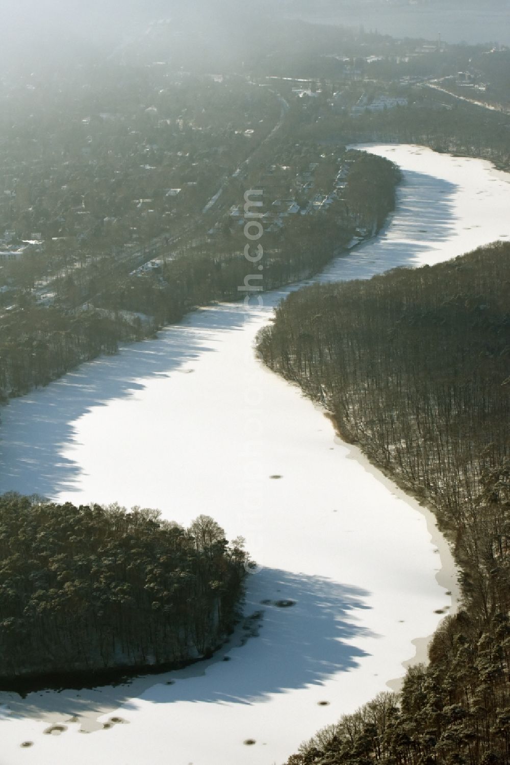 Berlin from above - Riparian areas on the lake area of Schlachtensee with wintry snowy ice in Berlin in Germany