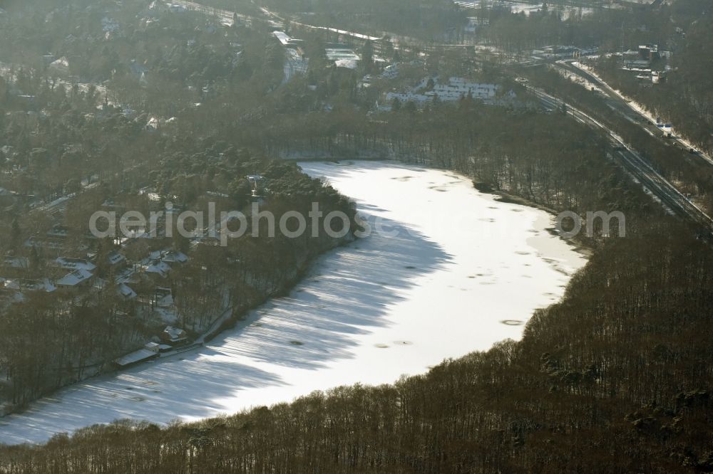 Aerial image Berlin - Riparian areas on the lake area of Schlachtensee with wintry snowy ice in Berlin in Germany