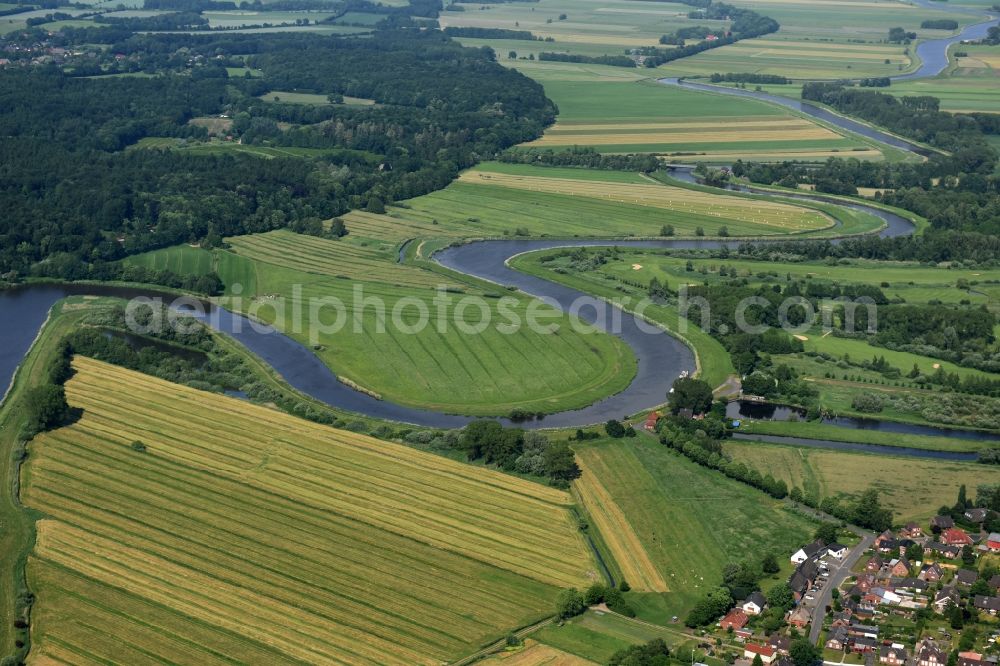 Münsterdorf from the bird's eye view: Curved loop of the riparian zones on the course of the river Stoer in Muensterdorf in the state Schleswig-Holstein