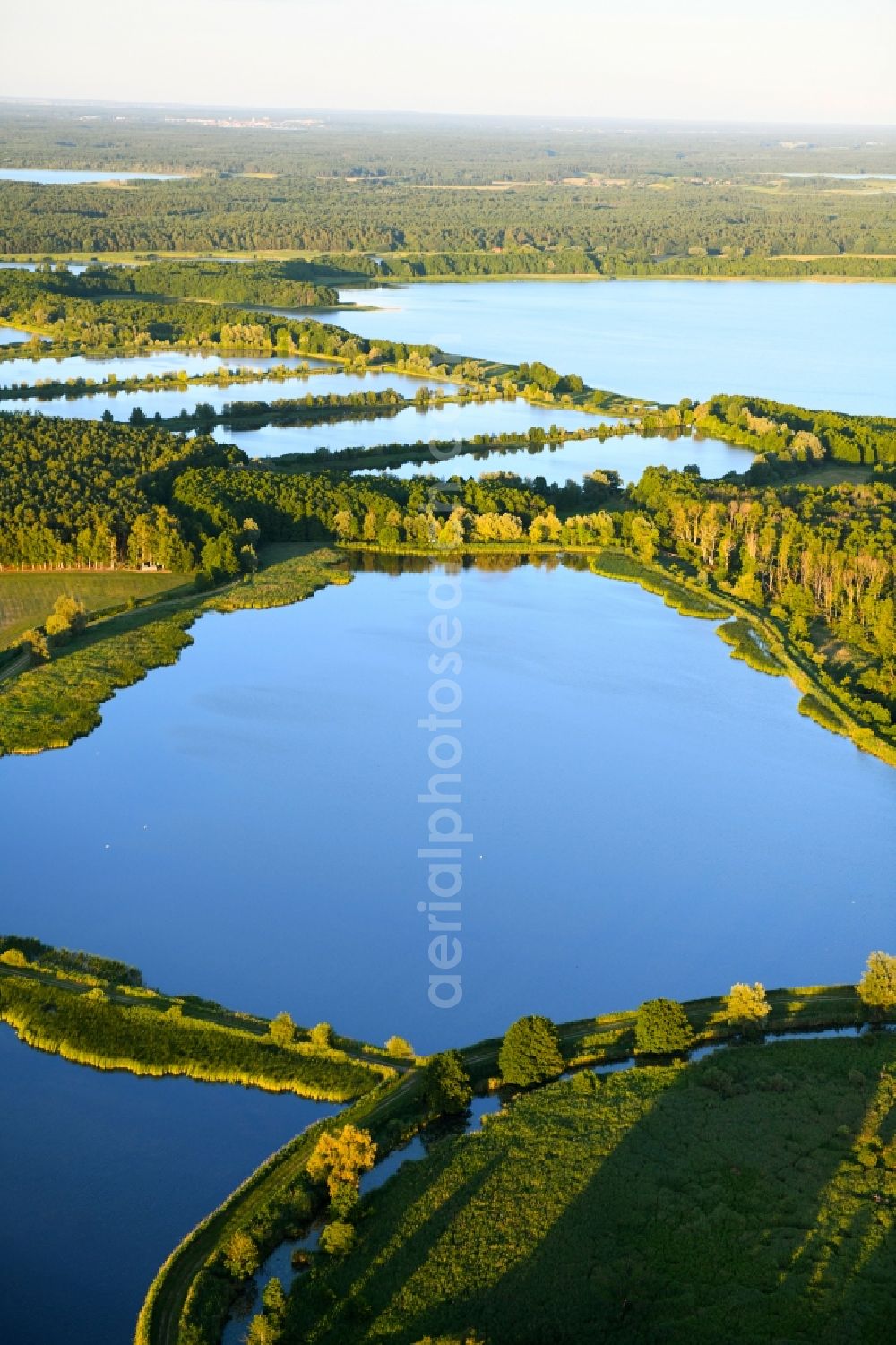 Boecker Mühle from above - Shore areas of the ponds for fish farming Caarpsee - Woterfitzsee in Boecker Muehle in the state Mecklenburg - Western Pomerania, Germany