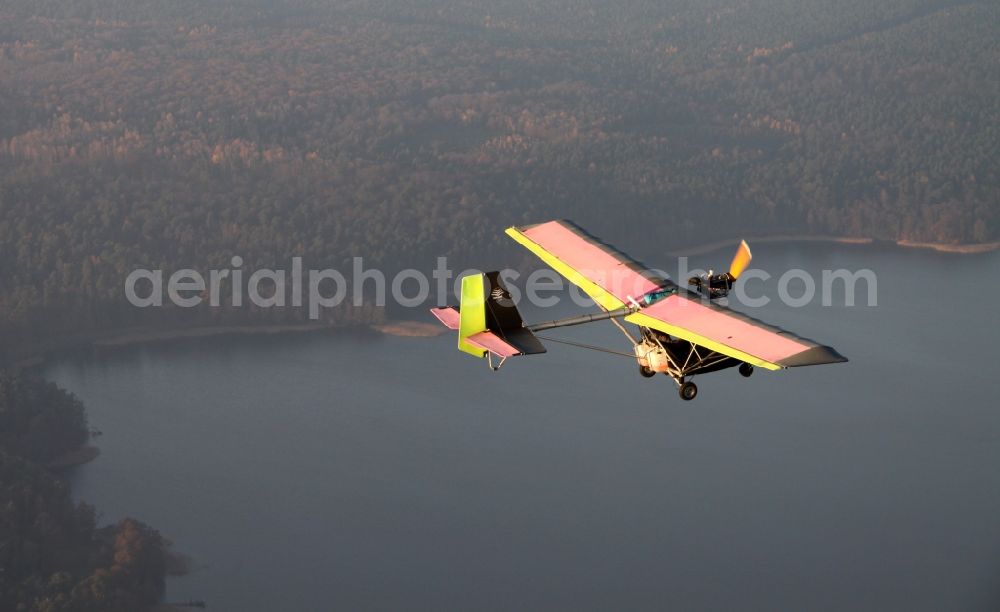 Werbellinsee from the bird's eye view: Microlight Ikarus C22 in flight over the Werbellinsee in Brandenburg