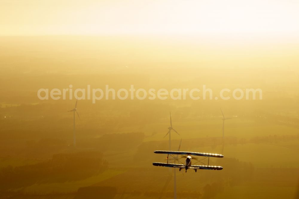 Oldendorf from above - Microlight aircraft Sunwheel D-MSLM while sunset over the lakes of moor near Oldendorf in Lower Saxony, Germany