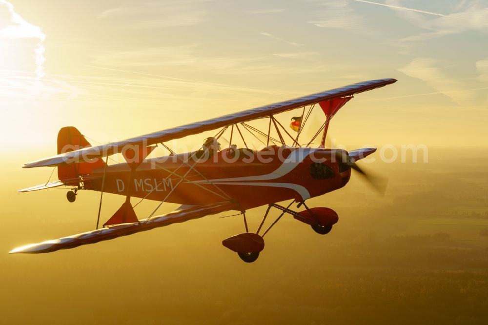 Aerial image Oldendorf - Microlight aircraft Sunwheel D-MSLM while sunset over the lakes of moor near Oldendorf in Lower Saxony, Germany