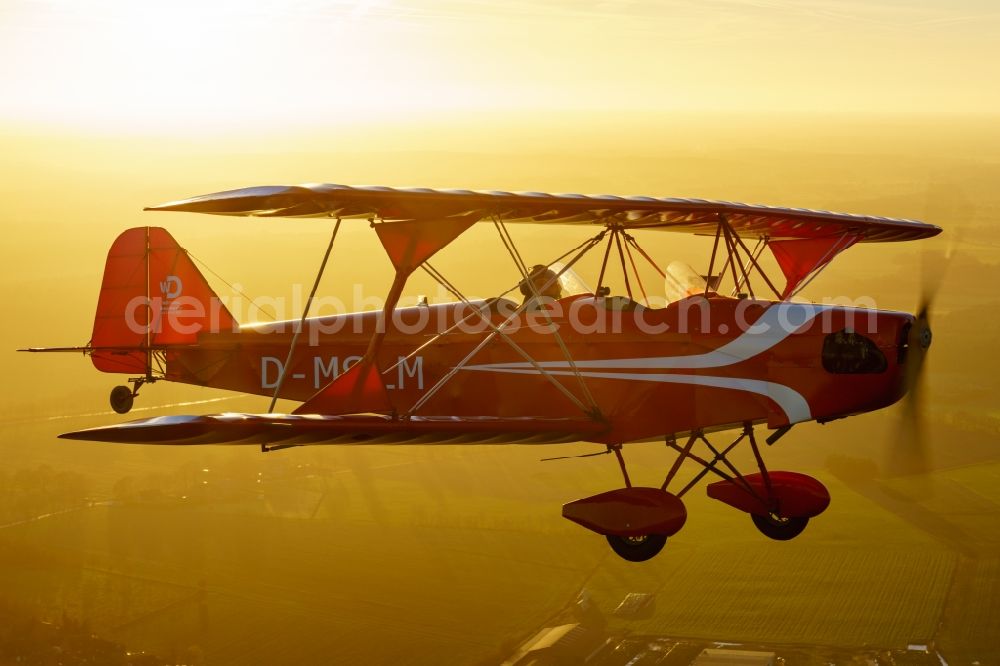 Aerial photograph Oldendorf - Microlight aircraft Sunwheel D-MSLM while sunset over the lakes of moor near Oldendorf in Lower Saxony, Germany