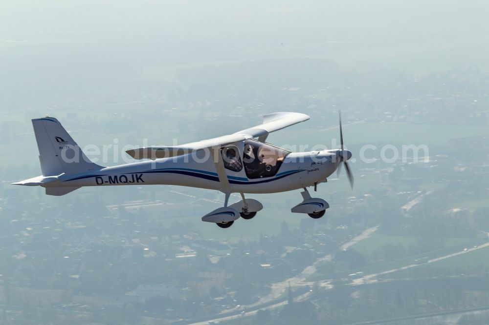 Hamm from above - View of an ultralight aircraft, a JK 05 Junior with the registration D-MQJK after starting on the airfield Hamm in North Rhine-Westphalia