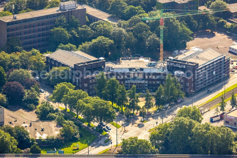 Duisburg from the bird's eye view: Construction site for reconstruction and modernization and renovation of an office and commercial building formerly the city indoor swimming pool on Walther-Rathenau-Strasse corner Duisburger Strasse in the district Obermarxloh in Duisburg at Ruhrgebiet in the state North Rhine-Westphalia, Germany