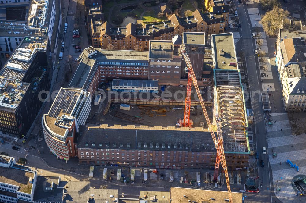 Bochum from the bird's eye view: Construction site for reconstruction and modernization and renovation of an office and commercial building Haus of Wissens (HdW) on place Willy-Brandt-Platz in Bochum at Ruhrgebiet in the state North Rhine-Westphalia, Germany