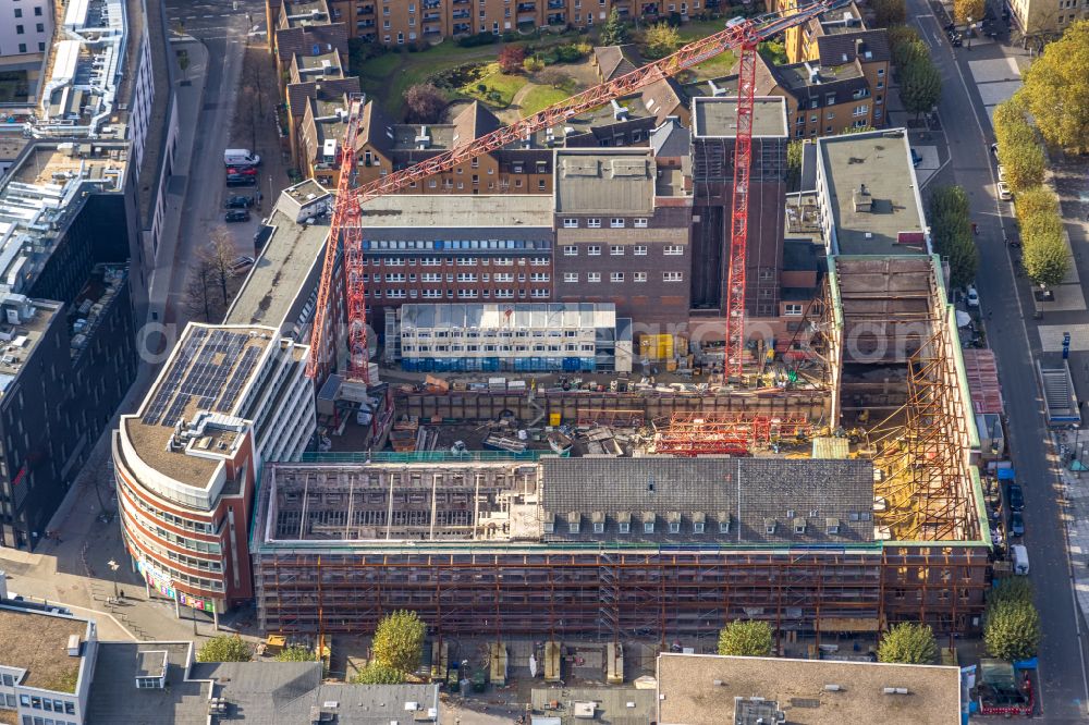 Bochum from the bird's eye view: Construction site for reconstruction and modernization and renovation of an office and commercial building Haus of Wissens (HdW) on place Willy-Brandt-Platz in Bochum at Ruhrgebiet in the state North Rhine-Westphalia, Germany