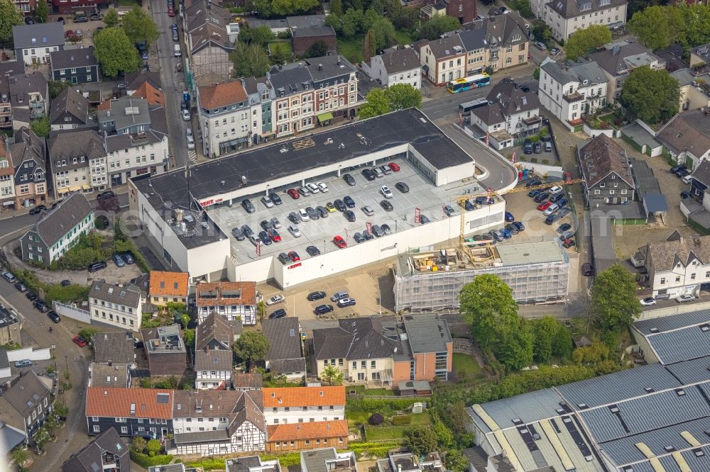 Essen from above - Construction site for reconstruction and modernization and renovation of an office and commercial building next to the REWE supermarket on Steinweg in the district Kettwig in Essen at Ruhrgebiet in the state North Rhine-Westphalia, Germany