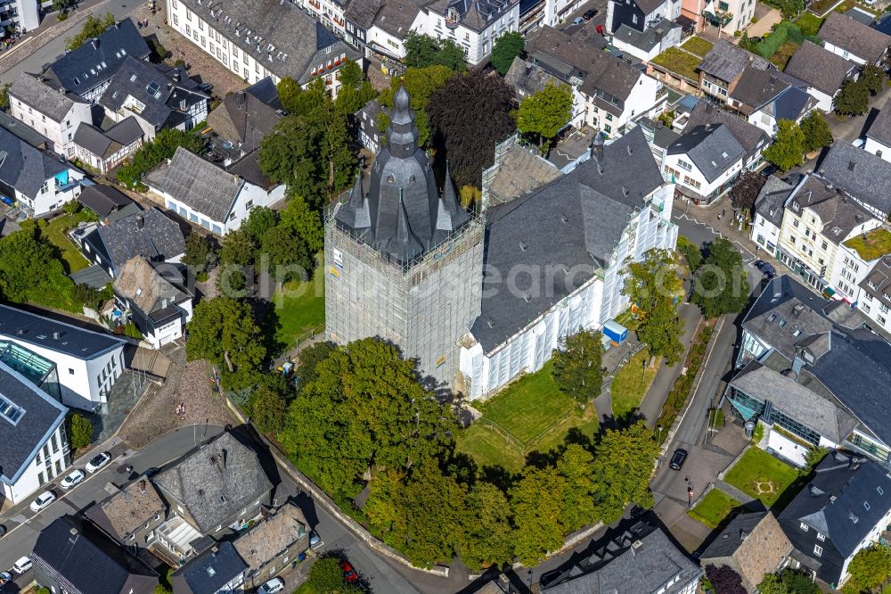 Brilon from the bird's eye view: Construction site for reconstruction and modernization and renovation of a church building of Probsteikirche on Schulstrasse in Brilon in the state North Rhine-Westphalia, Germany