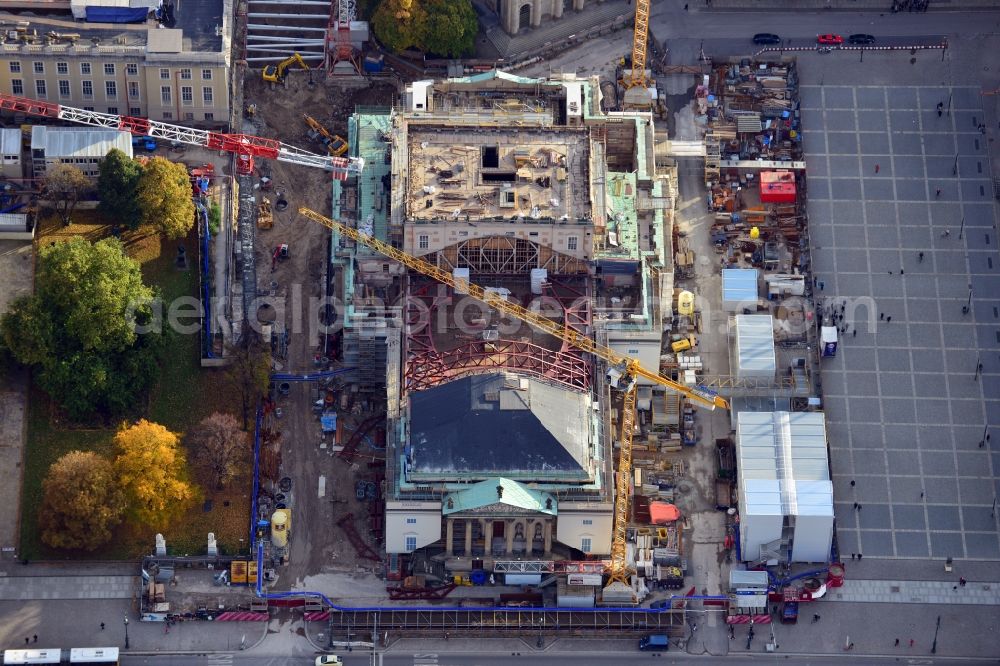 Berlin from the bird's eye view: View of the reconstruction and renovation of the building of the Staatsoper Unter den Linden in Berlin at Bebelplatz. It is the oldest opera house and theater building in Berlin. A new building will serve as stacks and warehouse for the Staatsoper Komplex. The architect HG Merz is a overseeing the reconstruction of the historical building complex