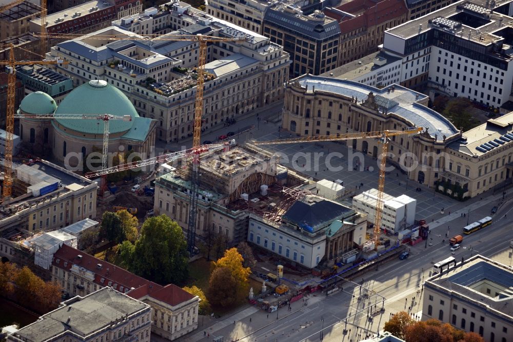 Berlin from above - View of the reconstruction and renovation of the building of the Staatsoper Unter den Linden in Berlin at Bebelplatz. It is the oldest opera house and theater building in Berlin. A new building will serve as stacks and warehouse for the Staatsoper Komplex. The architect HG Merz is a overseeing the reconstruction of the historical building complex