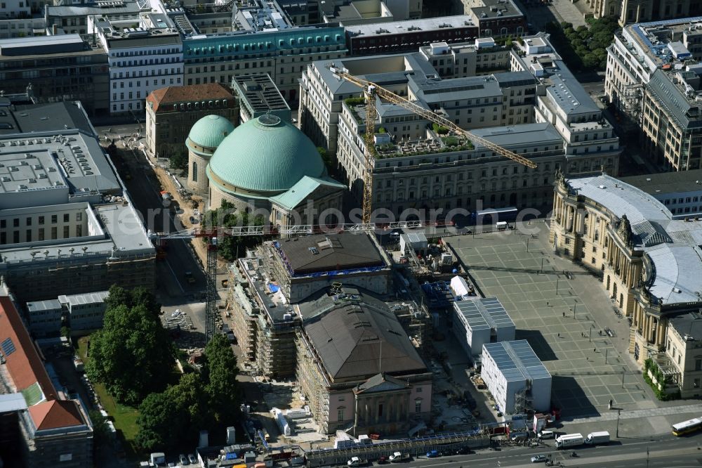 Berlin from the bird's eye view: View of the reconstruction and renovation of the building of the Staatsoper Unter den Linden in Berlin at Bebelplatz. It is the oldest opera house and theater building in Berlin. A new building will serve as stacks and warehouse for the Staatsoper Komplex. The architect HG Merz is a overseeing the reconstruction of the historical building complex