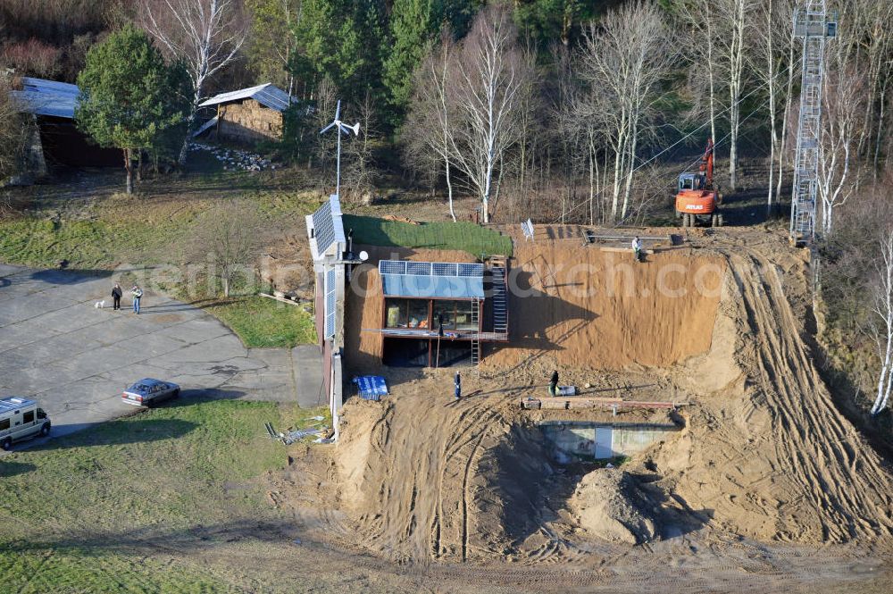 Aerial photograph Werneuchen - Zivile Nutzung / Konversion der alten Shelter / Flugzeughallen am Flugplatz Werneuchen. Umbau und Erweiterung eines Shelters mit umfangreichen Erdarbeiten zur Trockenlegung / Isolierung der Betonwände. Der Flugplatz diente seit den 1930er Jahren als Fliegerhorst und wurde danach von der Sowjetarmee als Flugplatz für Jagdbomber genutzt. Civilian use of the facilities of the airfield Werneuchen.