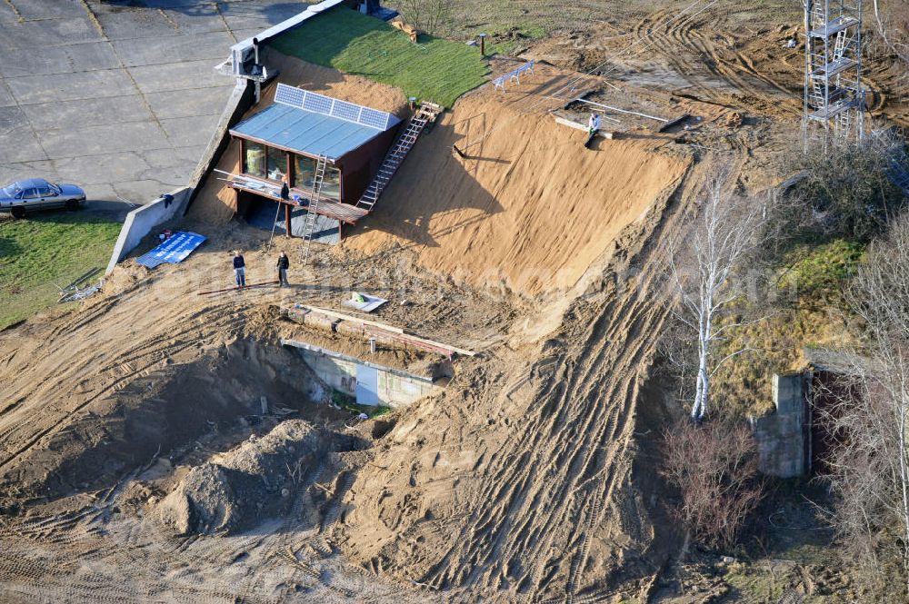 Werneuchen from the bird's eye view: Zivile Nutzung / Konversion der alten Shelter / Flugzeughallen am Flugplatz Werneuchen. Umbau und Erweiterung eines Shelters mit umfangreichen Erdarbeiten zur Trockenlegung / Isolierung der Betonwände. Der Flugplatz diente seit den 1930er Jahren als Fliegerhorst und wurde danach von der Sowjetarmee als Flugplatz für Jagdbomber genutzt. Civilian use of the facilities of the airfield Werneuchen.