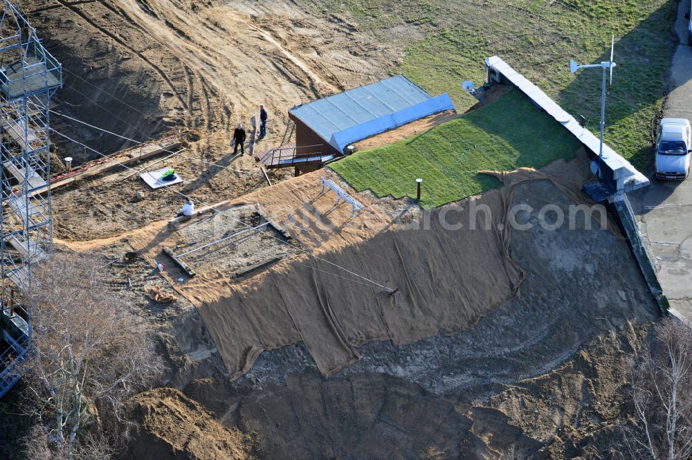 Aerial image Werneuchen - Zivile Nutzung / Konversion der alten Shelter / Flugzeughallen am Flugplatz Werneuchen. Umbau und Erweiterung eines Shelters mit umfangreichen Erdarbeiten zur Trockenlegung / Isolierung der Betonwände. Der Flugplatz diente seit den 1930er Jahren als Fliegerhorst und wurde danach von der Sowjetarmee als Flugplatz für Jagdbomber genutzt. Civilian use of the facilities of the airfield Werneuchen.