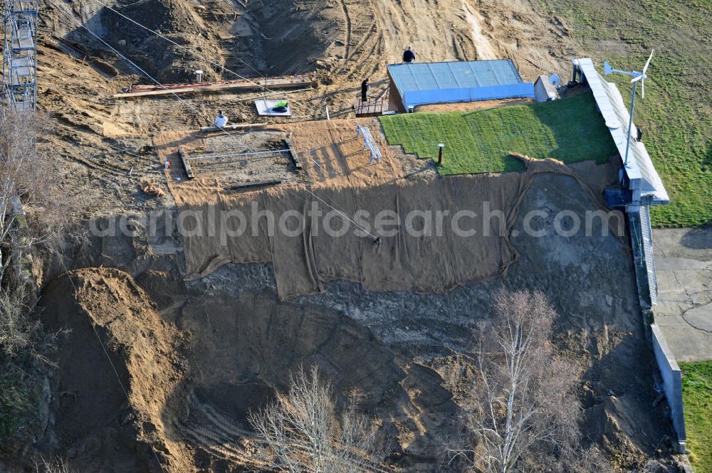 Aerial photograph Werneuchen - Zivile Nutzung / Konversion der alten Shelter / Flugzeughallen am Flugplatz Werneuchen. Umbau und Erweiterung eines Shelters mit umfangreichen Erdarbeiten zur Trockenlegung / Isolierung der Betonwände. Der Flugplatz diente seit den 1930er Jahren als Fliegerhorst und wurde danach von der Sowjetarmee als Flugplatz für Jagdbomber genutzt. Civilian use of the facilities of the airfield Werneuchen.