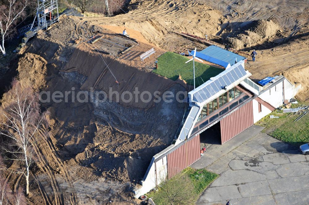 Werneuchen from the bird's eye view: Zivile Nutzung / Konversion der alten Shelter / Flugzeughallen am Flugplatz Werneuchen. Umbau und Erweiterung eines Shelters mit umfangreichen Erdarbeiten zur Trockenlegung / Isolierung der Betonwände. Der Flugplatz diente seit den 1930er Jahren als Fliegerhorst und wurde danach von der Sowjetarmee als Flugplatz für Jagdbomber genutzt. Civilian use of the facilities of the airfield Werneuchen.