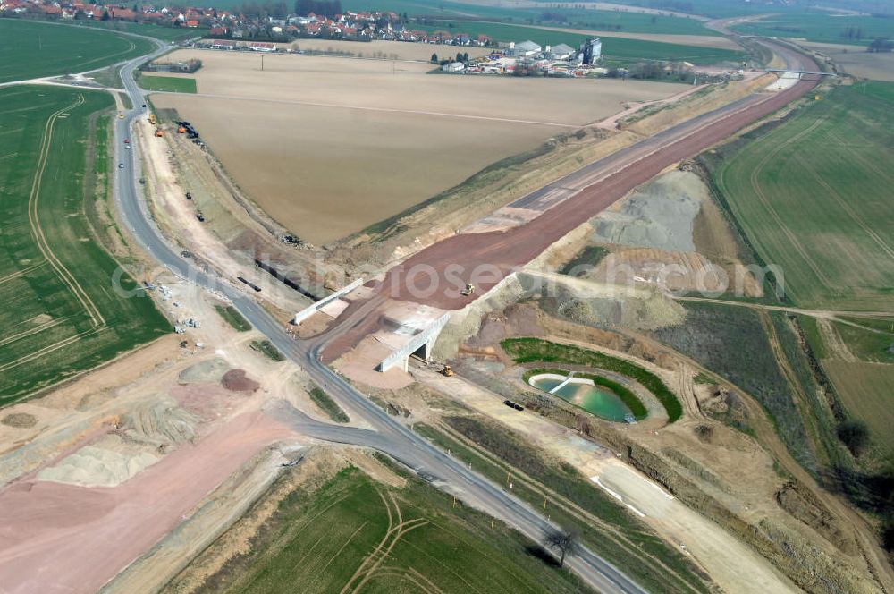 Neukirchen from the bird's eye view: Blick auf die Baustelle einer Unterführung der A4 für die Strassenverbindung zwischen Stregda und Neukirchen, sowie ein Regenrückhaltebecken. Der Neubau ist Teil des Projekt Nordverlegung / Umfahrung Hörselberge der Autobahn E40 / A4 in Thüringen bei Eisenach. Durchgeführt werden die im Zuge dieses Projektes notwendigen Arbeiten unter an derem von den Mitarbeitern der Niederlassung Weimar der EUROVIA Verkehrsbau Union sowie der Niederlassungen Abbruch und Erdbau, Betonstraßenbau, Ingenieurbau und TECO Schallschutz der EUROVIA Beton sowie der DEGES.