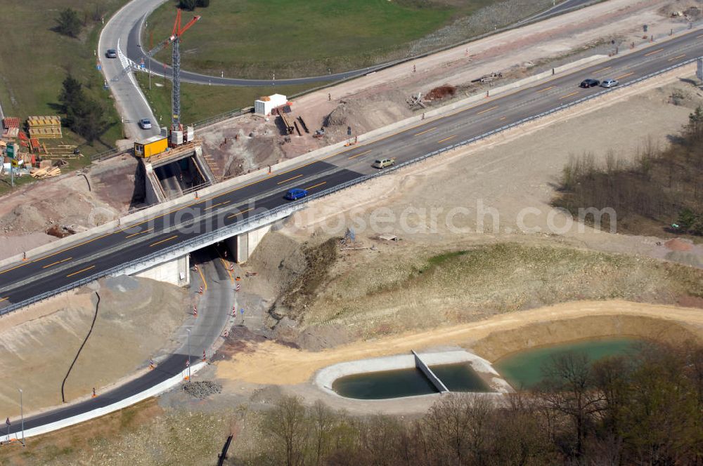 Eisenach from the bird's eye view: Blick auf die Baustelle einer Unterführung der A4 mit Regenrückhaltebecken östlich der Raststätte Eisenach. Der Neubau ist Teil des Projekt Nordverlegung / Umfahrung Hörselberge der Autobahn E40 / A4 in Thüringen bei Eisenach. Durchgeführt werden die im Zuge dieses Projektes notwendigen Arbeiten unter an derem von den Mitarbeitern der Niederlassung Weimar der EUROVIA Verkehrsbau Union sowie der Niederlassungen Abbruch und Erdbau, Betonstraßenbau, Ingenieurbau und TECO Schallschutz der EUROVIA Beton sowie der DEGES.