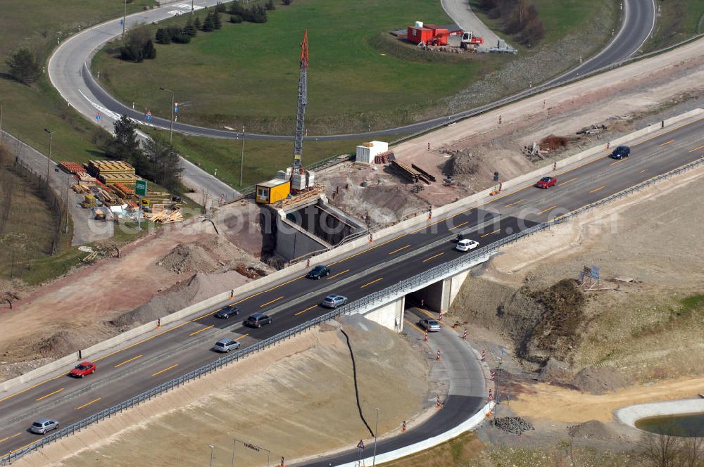 Aerial photograph Eisenach - Blick auf die Baustelle einer Unterführung der A4 östlich der Raststätte Eisenach. Der Neubau ist Teil des Projekt Nordverlegung / Umfahrung Hörselberge der Autobahn E40 / A4 in Thüringen bei Eisenach. Durchgeführt werden die im Zuge dieses Projektes notwendigen Arbeiten unter an derem von den Mitarbeitern der Niederlassung Weimar der EUROVIA Verkehrsbau Union sowie der Niederlassungen Abbruch und Erdbau, Betonstraßenbau, Ingenieurbau und TECO Schallschutz der EUROVIA Beton sowie der DEGES.