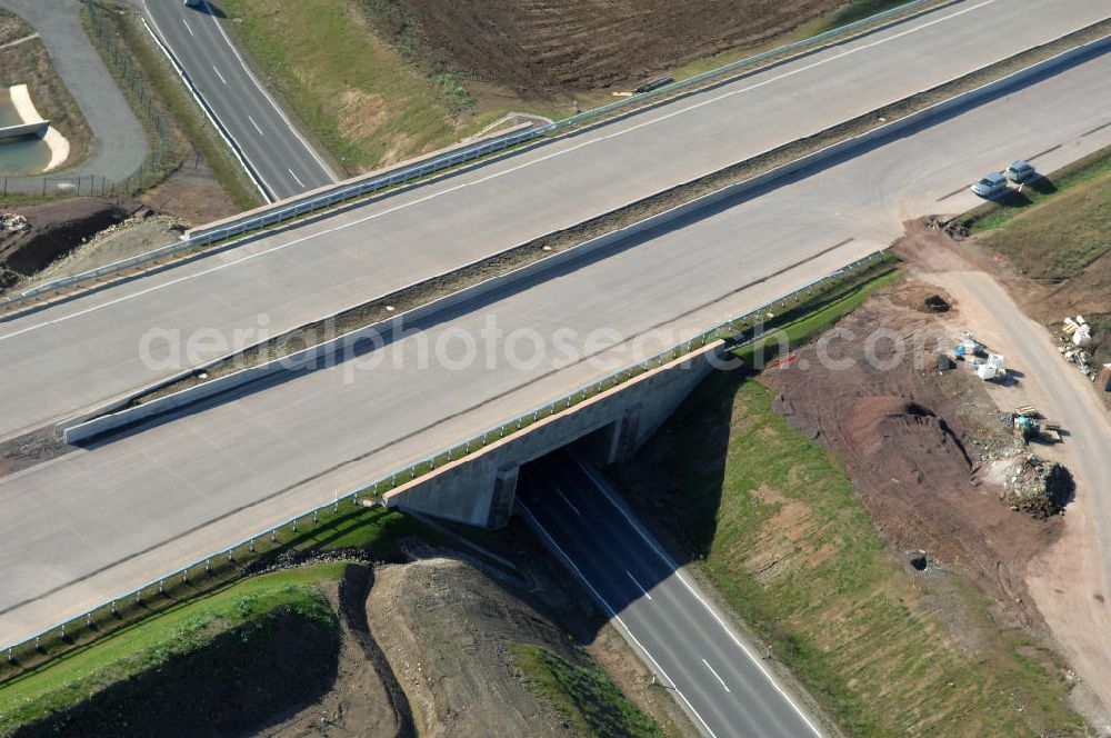 Neukirchen from the bird's eye view: Blick auf die Baustelle einer Unterführung der A4 für die Strassenverbindung zwischen Stregda und Neukirchen, sowie ein Regenrückhaltebecken. Der Neubau ist Teil des Projekt Nordverlegung / Umfahrung Hörselberge der Autobahn E40 / A4 in Thüringen bei Eisenach. Durchgeführt werden die im Zuge dieses Projektes notwendigen Arbeiten unter an derem von den Mitarbeitern der Niederlassung Weimar der EUROVIA Verkehrsbau Union sowie der Niederlassungen Abbruch und Erdbau, Betonstraßenbau, Ingenieurbau und TECO Schallschutz der EUROVIA Beton sowie der DEGES.