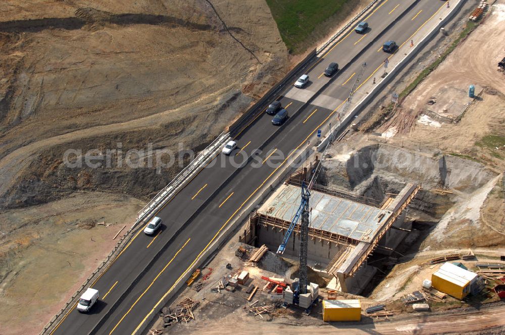 Aerial photograph Eisenach - Blick auf die Baustelle einer Unterführung der A4 westlich der Raststätte Eisenach. Der Neubau ist Teil des Projekt Nordverlegung / Umfahrung Hörselberge der Autobahn E40 / A4 in Thüringen bei Eisenach. Durchgeführt werden die im Zuge dieses Projektes notwendigen Arbeiten unter an derem von den Mitarbeitern der Niederlassung Weimar der EUROVIA Verkehrsbau Union sowie der Niederlassungen Abbruch und Erdbau, Betonstraßenbau, Ingenieurbau und TECO Schallschutz der EUROVIA Beton sowie der DEGES.