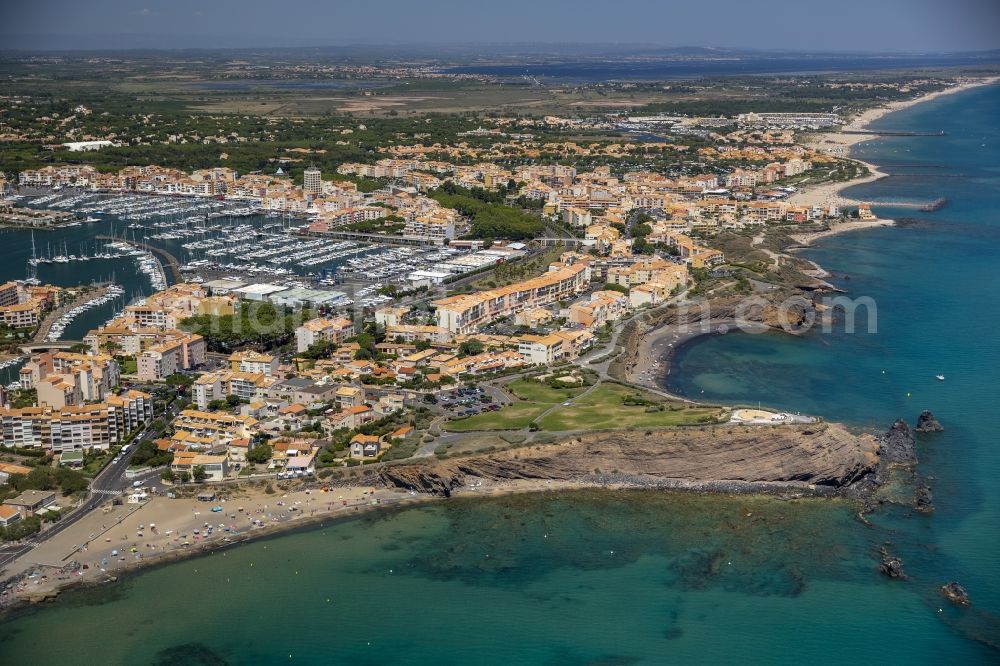 Agde from the bird's eye view: Tourists on the beach cliffs of Mediterranean coast landscape in Agde in the province of Languedoc-Roussillon in France