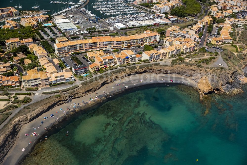 Aerial image Agde - Tourists on the beach cliffs of Mediterranean coast landscape in Agde in the province of Languedoc-Roussillon in France