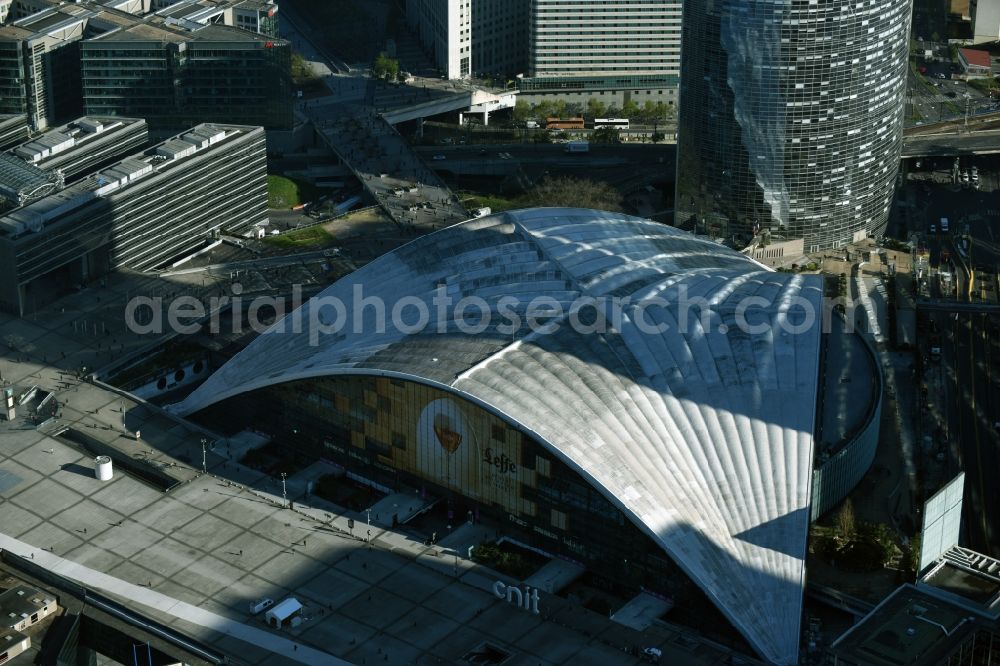 Paris from above - Convention center and office building Centre des nouvelles industries et technologies CNIT in the business quarter of highrise buildings La Défense in Puteaux in Ile-de-France, France