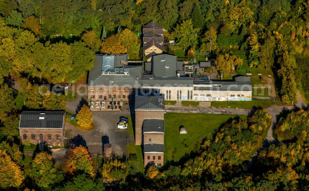 Essen from the bird's eye view: Events location and restaurant Machine House Essen - Zeche Carl in Essen in the state of North Rhine-Westphalia. The historic industrial building is located in an autumnal and colourful forest