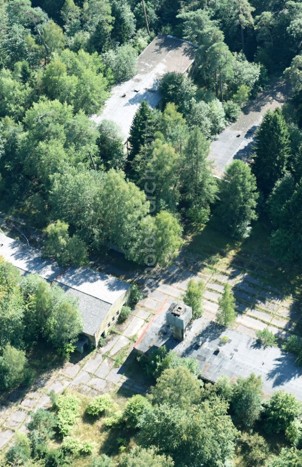 Aerial image Parmen - Decay and vegetation growth of the ruins of the building complex of the former military barracks of NVA Nationale Volksarmee formerly GDR in Parmen in the state Brandenburg