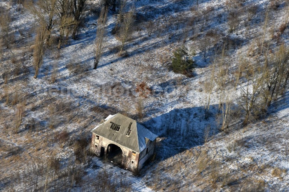 Aerial image Brandenburg an der Havel - Decaying former military building in a snow-covered park on Magdeburger Strasse in Brandenburg an der Havel in the state of Brandenburg. The area is being redeveloped as a commercial and industrial area