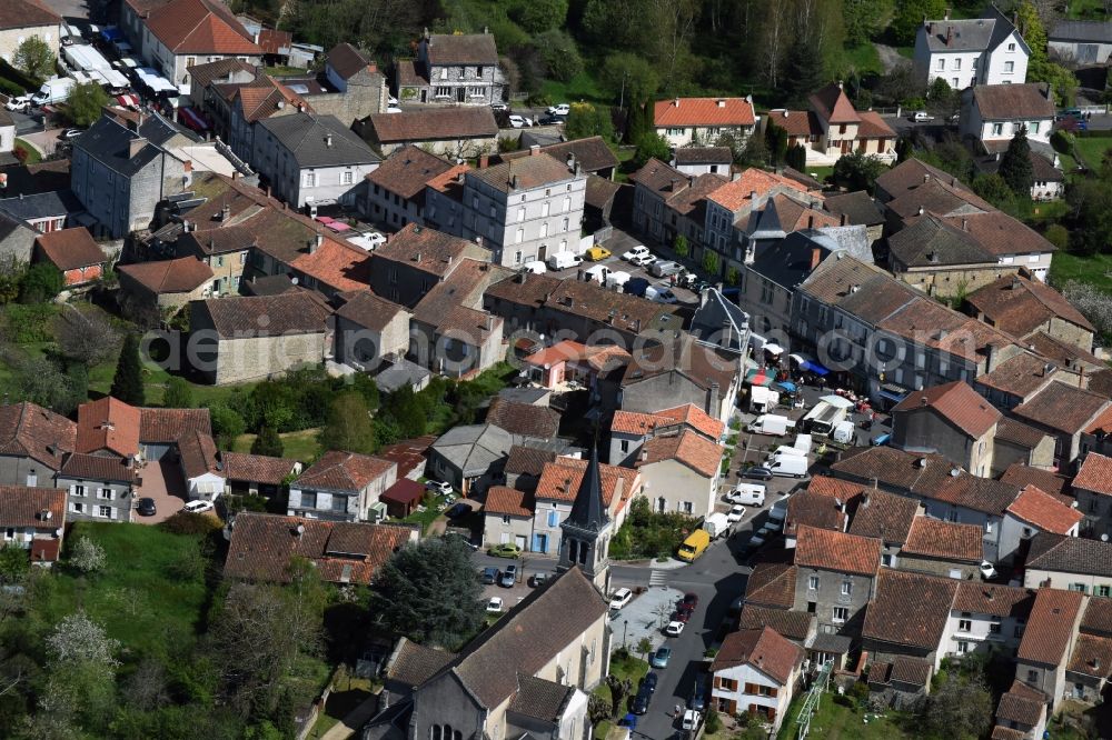 Piégut-Pluviers from the bird's eye view: Sale and food stands and trade stalls in the market place at the town hall of the inner city center in Piegut-Pluviers in Aquitaine Limousin Poitou-Charentes, France