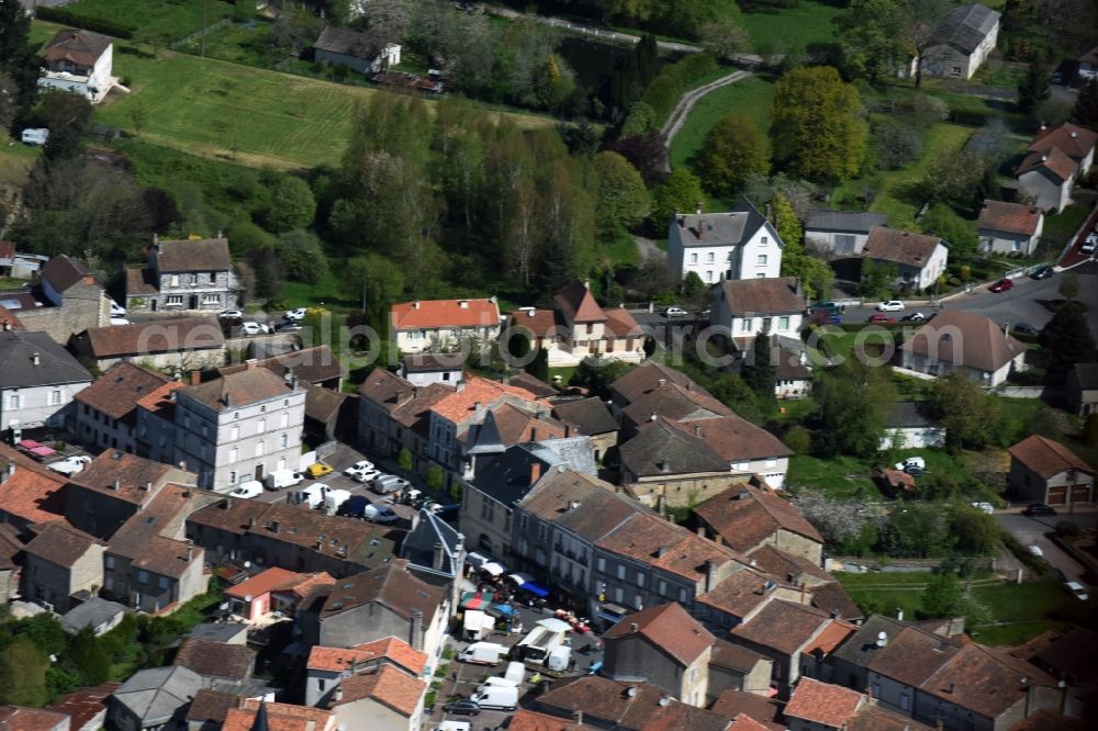 Aerial image Piégut-Pluviers - Sale and food stands and trade stalls in the market place at the town hall of the inner city center in Piegut-Pluviers in Aquitaine Limousin Poitou-Charentes, France