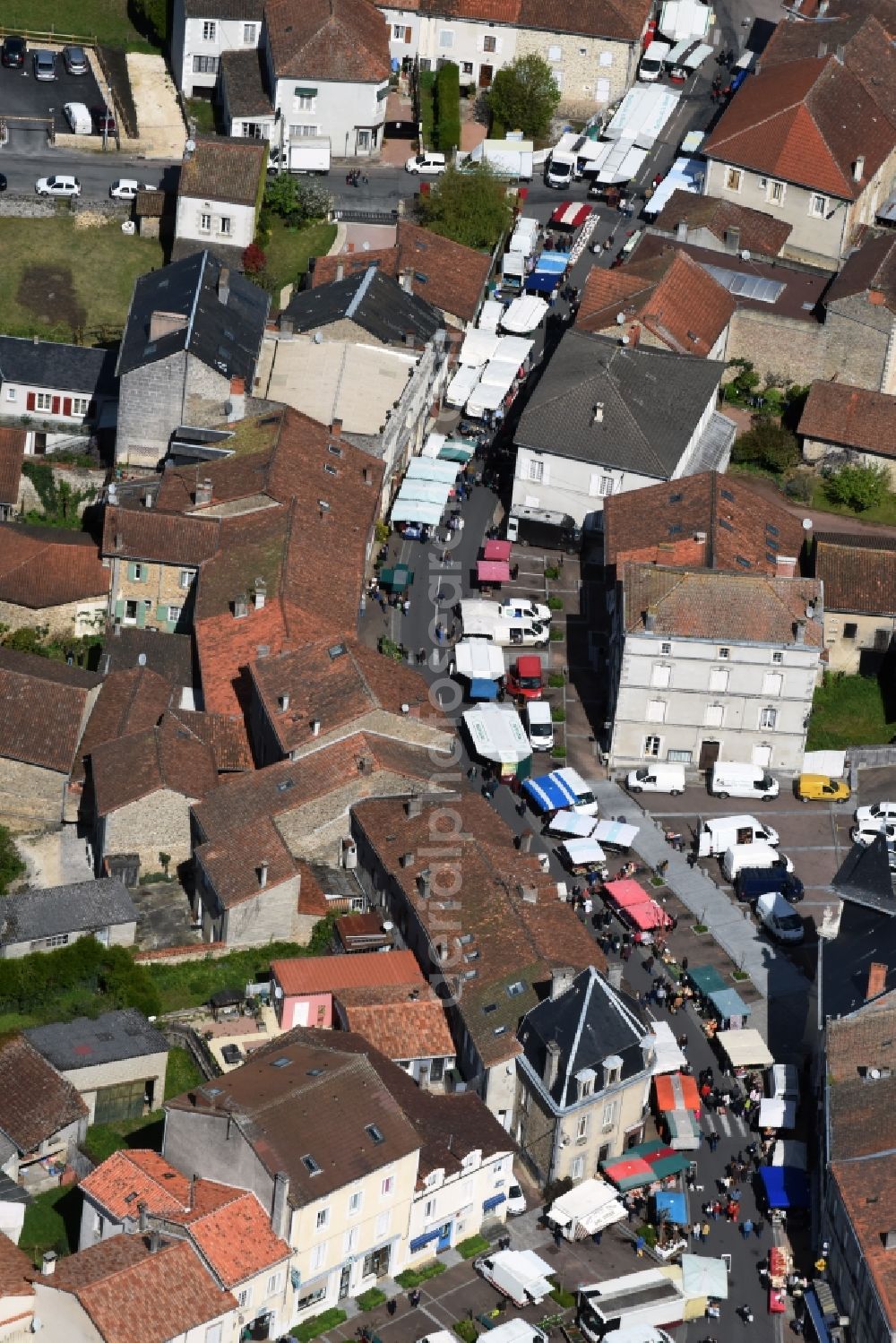 Aerial image Piégut-Pluviers - Sale and food stands and trade stalls in the market place at the town hall of the inner city center in Piegut-Pluviers in Aquitaine Limousin Poitou-Charentes, France