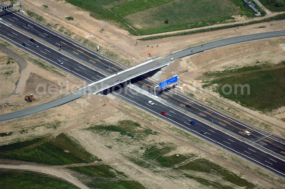 Schönefeld from the bird's eye view: Blick auf den Bereich der Stadtautobahn / Zubringer A113n als südöstliches Tor zur Hauptstadt nach der Verkehrsfreigabe. Unter Berücksichtigung des Flughafens Berlin Brandenburg International wurde eine Verkehrskonzeption für den Ausbau des Straßennetzes im Raum Berlin-Schönefeld erarbeitet, die zwei Stufen umfasste. Die erste Stufe sah den vierstreifigen Ausbau der Bundesstraßen B 96a und B 179 mit der Anbindung des Flughafens über zwei Knotenpunkte vor. Inhalt der zweiten Stufe war der Anschluß der Bundesautobahn A 113 neu an die B 96a und B 179. SCHÜßLER Plan Ingenieurgesellschaft, BATEG, EUROVIA, Schüßler Plan