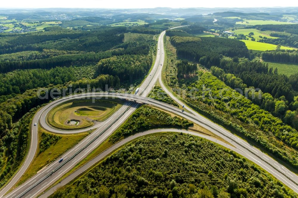 Wenden from the bird's eye view: Traffic flow at the intersection of the motorway A4 and highway B54 with the exit Krombach in Wenden in the state of North Rhine-Westphalia. The distinct course of the roads and bridge construction is located in a forest in the West of Krombach