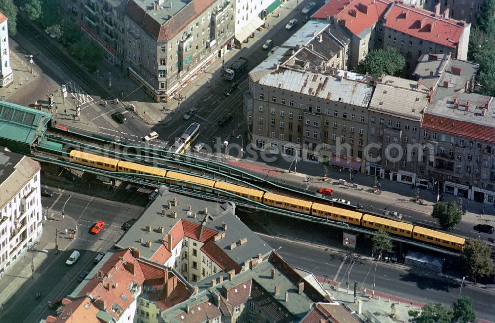 Aerial image Berlin - The traffic junction intersection Schoenhauser-Allee, Danziger-Strasse, Kastanienallee, of poplars is spanned by Metro Station Eberswalde Strasse. Just driving a subway in the direction of downtown