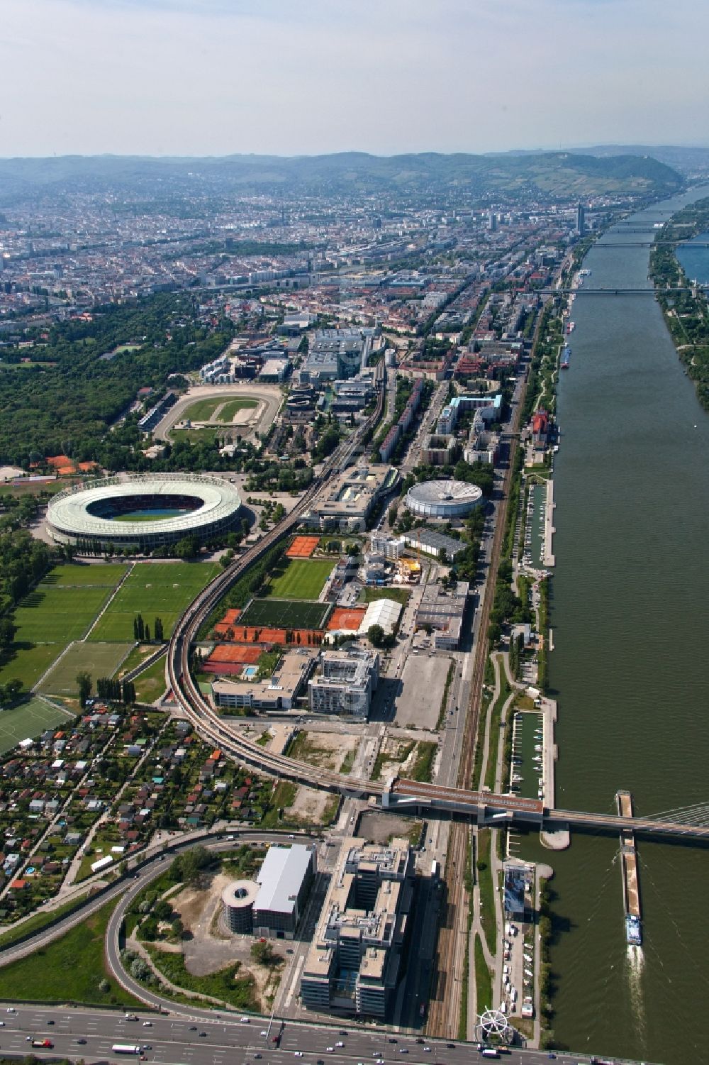 Wien from above - View of the course of a railway line over a bridge on the Danube passing the Ernst-Happel-Stadion in Vienna in Austria