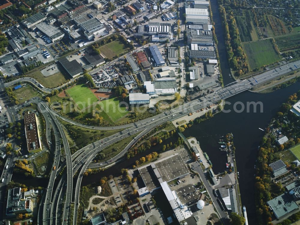 Berlin from above - Course of the federal motorway A100 and A113 in the area of the exit Grenzallee in the Neukoelln part of Berlin in Germany. The A100 joins the A113 towards the South. The motorway passes the harbour of Britz-East in the area which mainly consists of company compounds and commercial areas