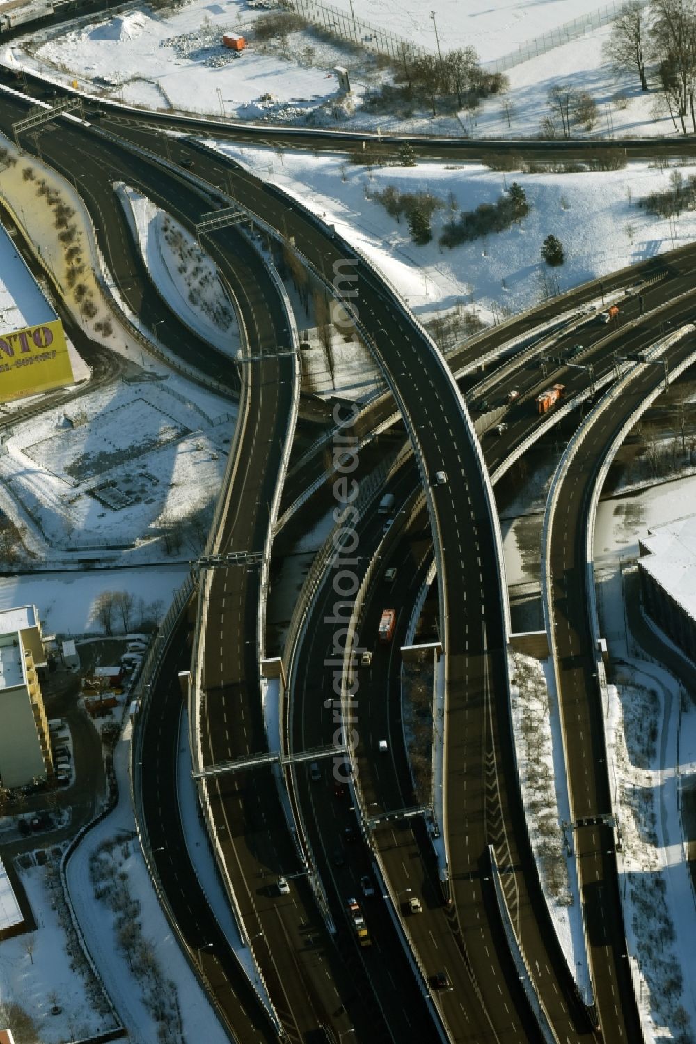 Aerial image Berlin - Wintry snowy course of the federal motorway A100 and A113 in the area of the exit Grenzallee in the Neukoelln part of Berlin in Germany