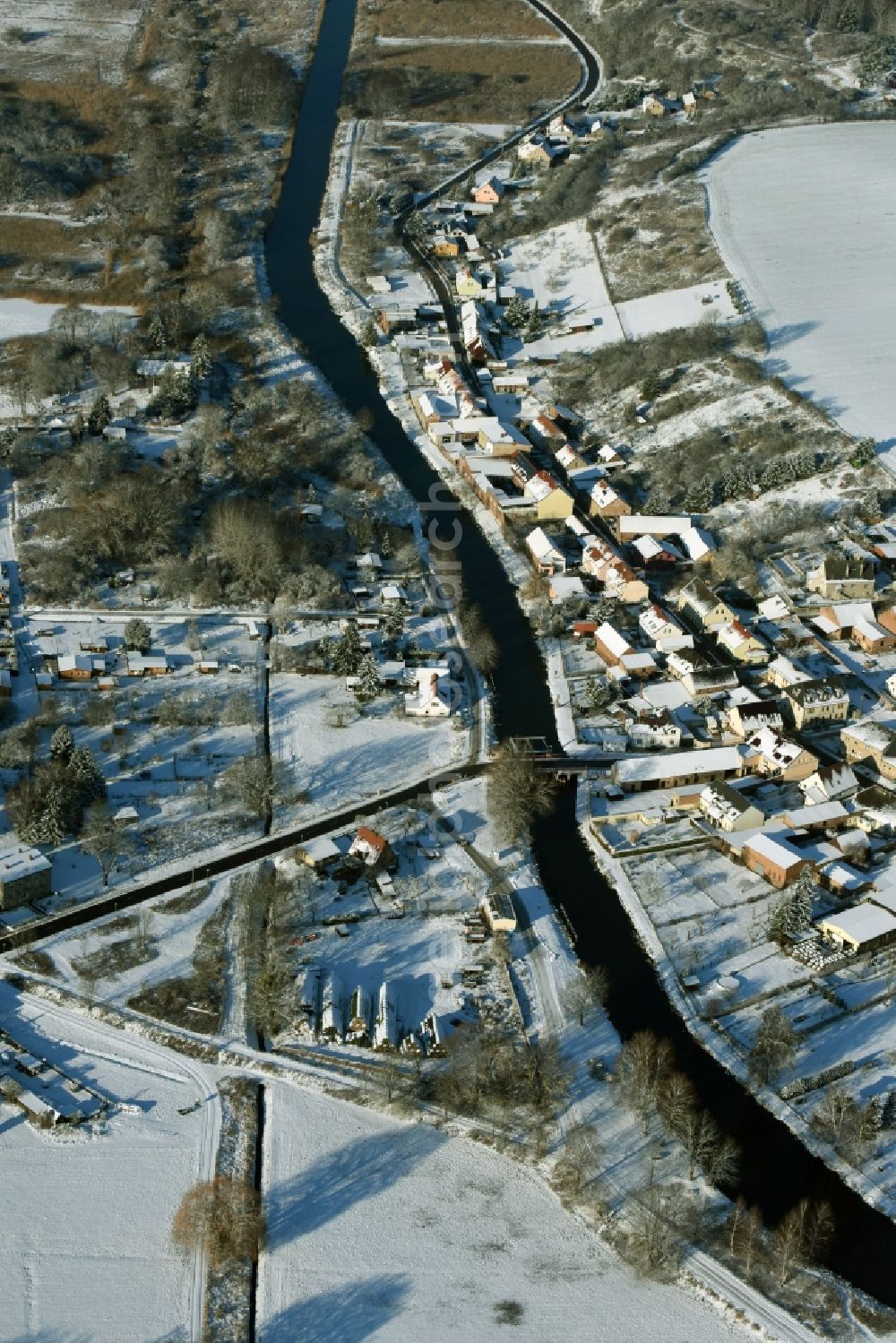 Niederfinow from above - View of the snow-covered winterly village of Niederfinow along the river of Old Finow in the state of Brandenburg